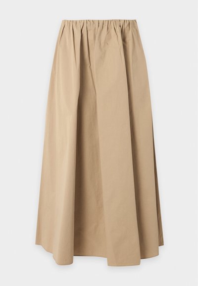 Jupe beige longueur cheville avec une taille élastique et une coupe légèrement froncée et ample.