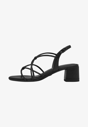 Black heeled sandals with a block heel, featuring thin, crisscross straps and an adjustable ankle buckle. Smooth leather texture.