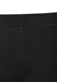 Sorte stretchleggings med en glat tekstur, elastisk taljebånd og et tætsiddende design uden synlige mønstre eller hardware-detaljer.