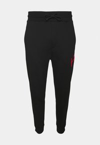 Schwarze Jogginghosen aus weichem Stoff, mit einem Kordelzugbund und einem roten gestickten Logo am linken Oberschenkel. Schmal zulaufendes Bein-Design.