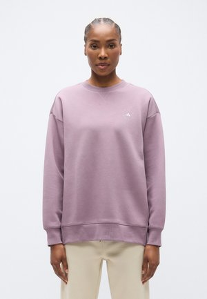 Lilla crewneck-genser med ribbestrikkede mansjetter og kant, med en liten hvit logo på brystet og en glatt, myk tekstur.