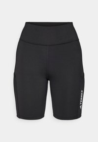 Černé sportovní šortky vyrobené z pružného materiálu, s vysokým pasem, bočními kapsami a bílým logem na jedné nohavici.