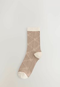 Beige Knöchelsocke mit einem cremefarbenen, gerippten Bündchen, das ein dezentes Blumemuster in hellbeige und kleine gepunktete Akzente aufweist.