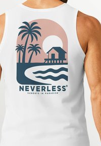 White sleeveless shirt featuring a graphic design with palm trees, a sunset, and a house on stilts. Text reads "NEVERLESS SUNDAYS IN PARADISE."