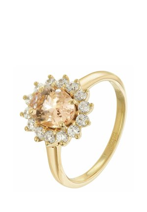 Gold ring with a large oval peach-colored center stone surrounded by a halo of small round clear diamonds.