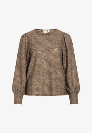 Gaiši brūna blūze ar gariem piedurknēm, vilnainu tekstūru un savāktām piedurknēm. Apaļa kakla līnija, izgatavota no mīksta auduma. Redzama zīmola etiķete.