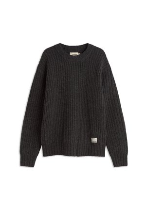 Donkergrijze geribbelde trui met een ronde halslijn, een ontspannen pasvorm en zijsplitten. Heeft een klein label aan de onderzoom. Textuurstof.