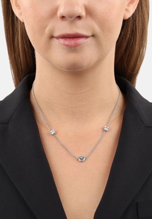 Collar de cadena de plata que presenta tres piedras redondas, alternando entre claras y oscuras, con una textura suave y un diseño minimalista.