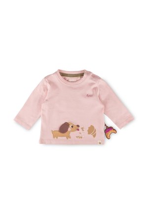Rosa langärmliges Babyshirt mit Knöpfen an der Schulter, Hund- und Croissant-Motiven sowie einem kleinen angenähten Stoffcroissant an der Seite.