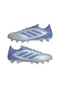 Light purple soccer cleats with a shiny silver upper, featuring green accents and three parallel stripes. Textured surface and molded studs.