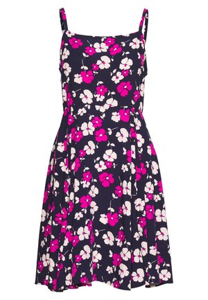 Robe florale avec bretelles réglables, arborant un fond marine et un motif de fleurs roses et blanches. Tissu léger, conception en A.