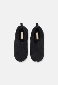 Black, fluffy slippers made of soft textile. Round toe design with a textured surface and back pull tab for easy wear.