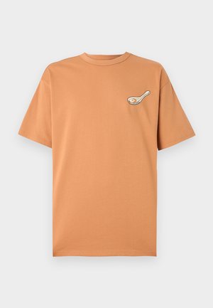 Short-sleeve, crew neck t-shirt in light orange, made of cotton, featuring a small white and black graphic on the chest.