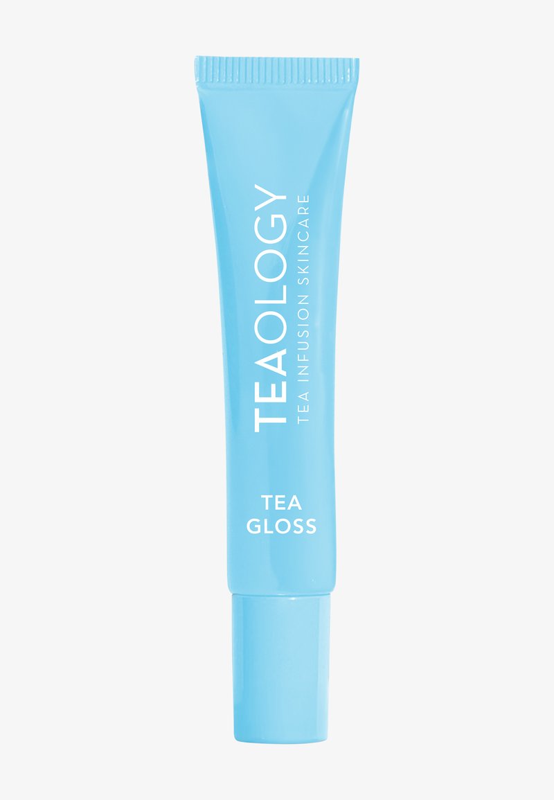 Tealogy Gloss à thé dans un tube bleu souple. Présente un texte blanc et une texture lisse. Le bouchon est transparent, ce qui permet une application facile.
