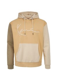 Huvtröja med en blandning av beige och tan-paneler, en ficka framtill och en vit signatur-logo på bröstet.