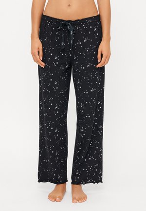 Svarta loungebyxor med stjärnmönster, med dragsko i midjan, vid bendesign och mjukt, lätt material.
