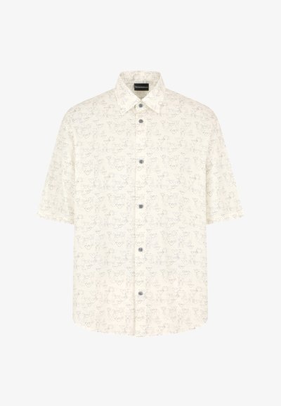 Camicetta a maniche corte con bottoni in crema, con un sottile motivo floreale. Presenta un colletto a punta e cinque bottoni sul davanti.