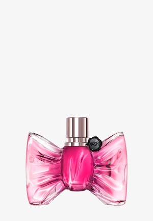 Pink bow-shaped glass perfume bottle with metallic cap and small black seal marked "V&R" on the upper right side.