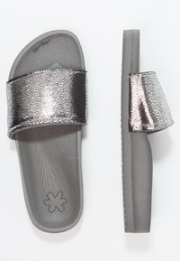 Gray slide sandals featuring a metallic cracked effect strap. Textured insole with a slight arch and minimalist design. Non-slip sole.