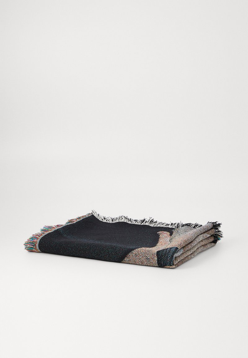 Woven blanket featuring a textured dark blue and multicolored pattern, finished with fringe edges. Folded neatly for display.