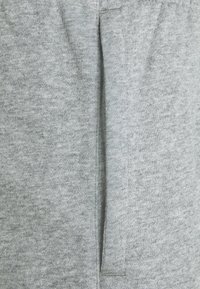 Gray cotton fabric with a soft texture, featuring a central seam and slight variation in shading. Simple, unadorned design.