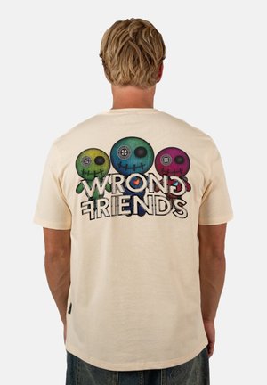Cream-colored cotton t-shirt featuring a graphic design of three colorful skulls and the text “WRONG FRIENDS” on the back.