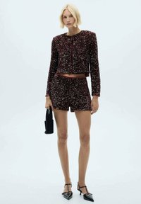 Burgundy sequined two-piece outfit featuring a cropped jacket and matching shorts; textured with a fitted design and contrasting trim.