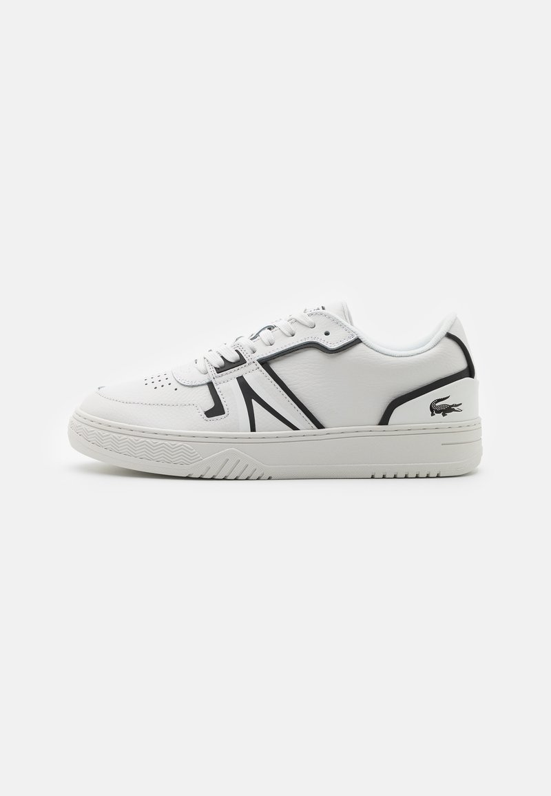 White sneaker with black accents, leather exterior, perforated toe box, flat laces, textured rubber sole, and Lacoste logo on the heel.