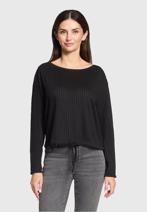 Schwarzes, geripptes Langarmshirt mit weitem Ausschnitt, verstellbarem Kordelzugsaum und legerem Schnitt, kombiniert mit grauen Jeans.