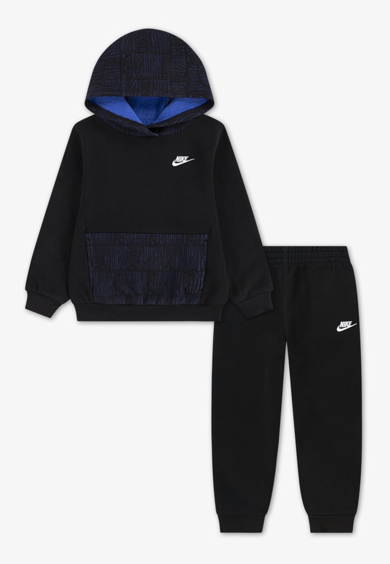 Zwarte Nike sweatshirt met een gepatternde capuchon, kangoeroezak en wit logo, gecombineerd met bijpassende zwarte sweatpants met logo op het been.