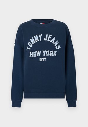 Marineblauwe sweatshirt met "TOMMY JEANS NEW YORK CITY" in grote witte letters gedrukt. Voorzien van een ronde halslijn en geribde manchetten.
