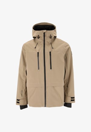 Vedenpitävä beige takki hupulla, jossa on kaksi vetoketjullista etupoketia, mustat vetoketjut ja yksityiskohdat, sekä säädettävät nyörit kaulassa ja hihansuissa.