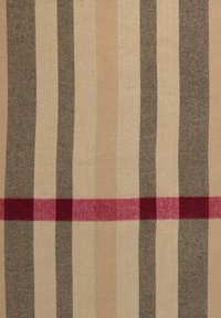 Tissu tissé présentant des rayures beiges, brunes et tan alternées, avec une bande à carreaux rouge vif pour le contraste. Texture lisse.