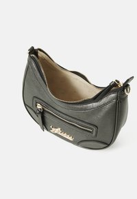 Borsa a spalla in pelle nera con forma curva, zip dorata e dettaglio con logo. L'interno presenta una fodera beige con motivo del marchio.