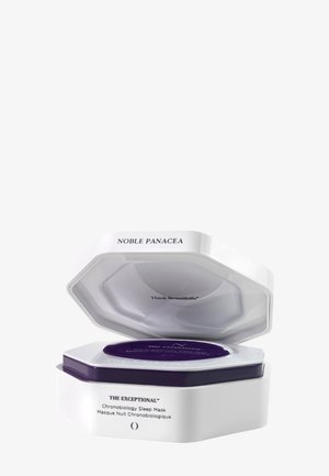 Sechseckiger weißer und violetter Behälter mit offenem Deckel, der "Chronobiology Sleep Mask" innen zeigt und den Text "Noble Panacea" am Deckelrand.