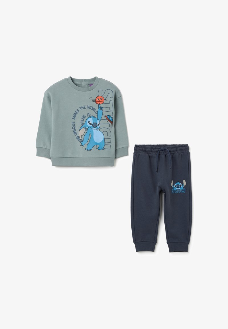 Two-piece children's outfit: light green sweatshirt with blue Stitch graphic and text, paired with dark blue drawstring sweatpants featuring Stitch.