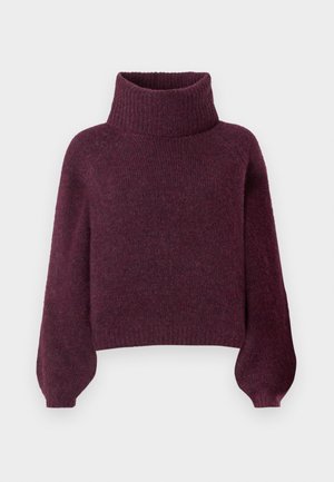 Burgundijas adīta džemperis ar augstu ribotu turtleneck, pārāk lielām balona piedurknēm un nedaudz kroptu apakšmalu. Mīksts, teksturēts audums.