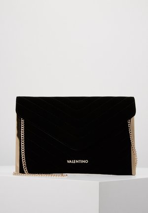 Black velvet Valentino clutch with chevron stitching, gold chain strap, and gold hardware accents displayed on white surface.