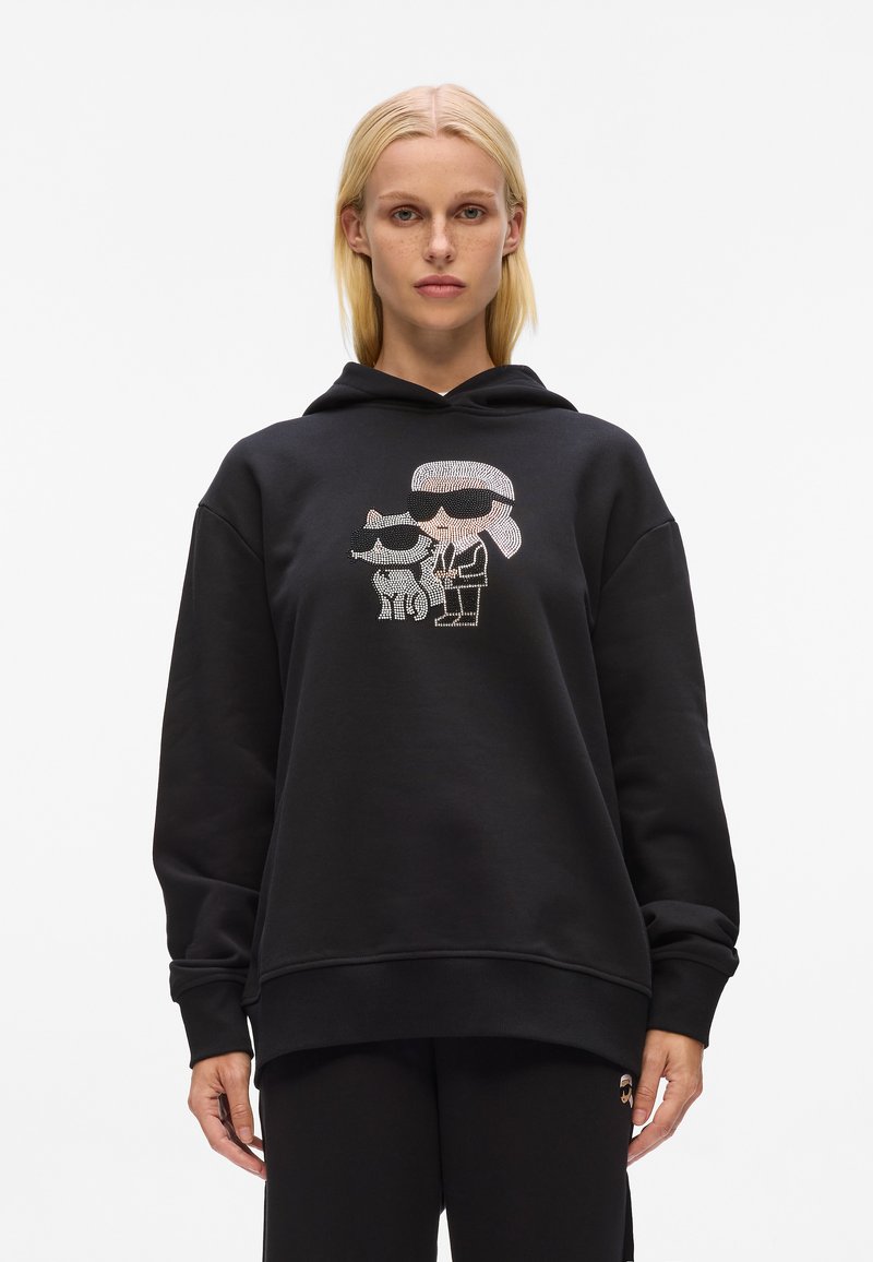 Felpa nera oversize con un design grafico di due personaggi con occhiali da sole, realizzata in morbido tessuto misto cotone.