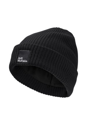 Bonnet en tricot noir avec texture côtelée, présentant un revers et une petite étiquette cousue avec "Jack Wolfskin" en blanc.