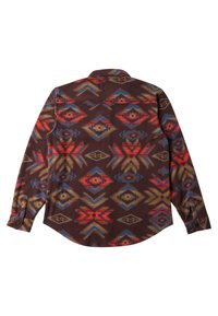 Langsleeve shirt met een bruine achtergrond, voorzien van een multicolore geometrisch patroon in rood, blauw en beige. Met knoopsluitingen bij de mouwen.