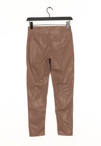 Hnědé kalhoty z umělé kůže slim střihu, lesklé textury a hladkým předním dílem. Mají jednoduch�ý pas a žádnou viditelnou kovovou sponu ani kapsy.