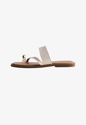 Flat brown sandal with two beige leather straps, one wide across the foot and a narrow toe loop with a small gold ball detail.