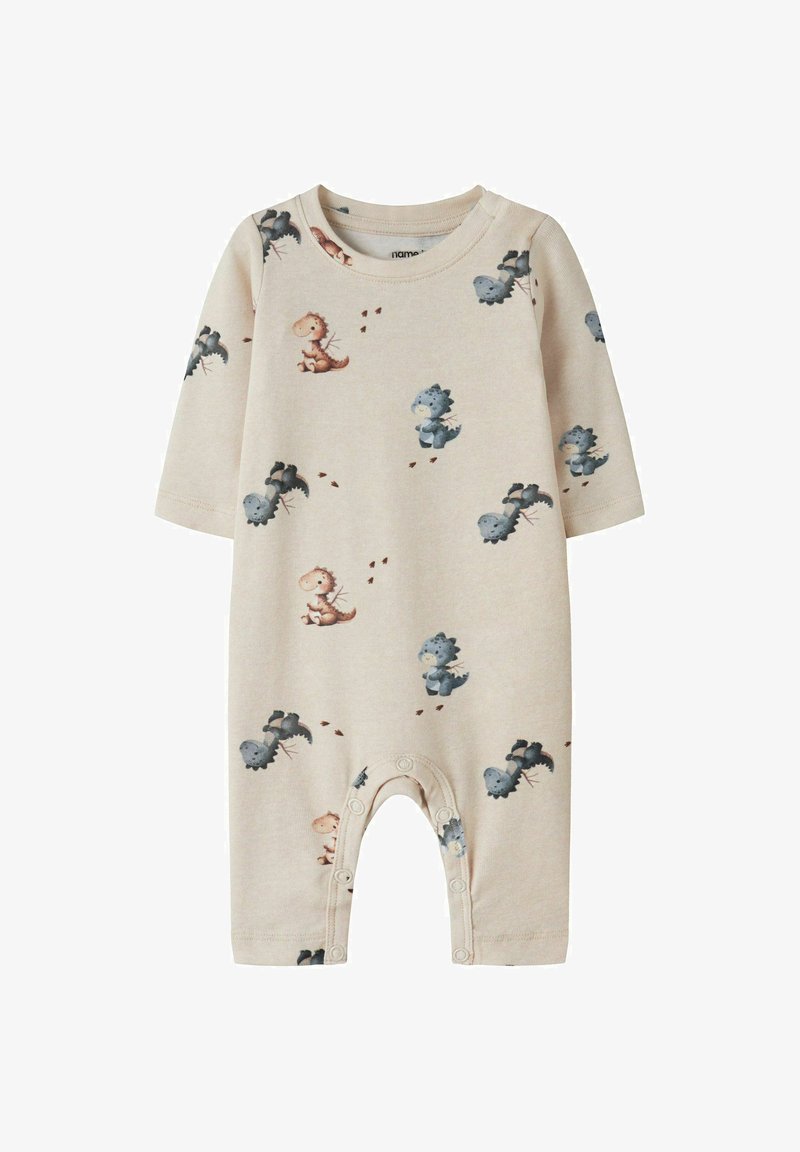 Combinaison beige pour bébé à manches longues, fermeture pression aux jambes, avec un motif de petits dinosaures dessinés en bleu et marron.