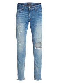 Light blue denim jeans with a slim fit, featuring distressed patches and ripped areas. Classic five-pocket design; zipper fly with button closure.