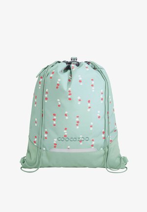 Hellgrüner Rucksack mit Kordelzug, rot-weißem Punktmuster, Frontlogo und verstellbaren Schnüren vor weißem Hintergrund.