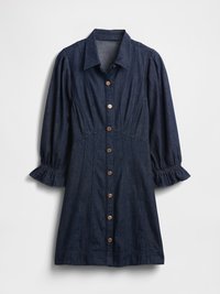 Abito in denim blu scuro con bottoni frontali, colletto e maniche a sbuffo con polsini elasticizzati. Presenta cuciture decorative e bottoni di legno.
