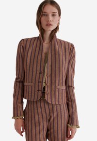 Gestreepte blazer in paarse en oranje tinten, cropped ontwerp met schouderplooien, twee voorzakken en knoopaccenten. Gelaagd stof.