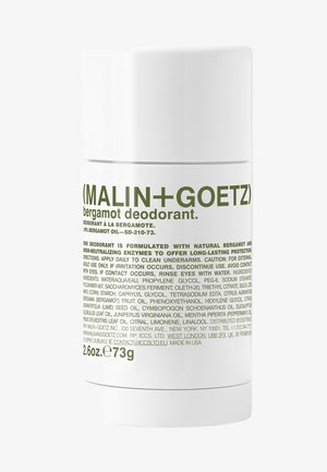 White cylindrical deodorant stick with green text. Contains natural bergamot and odor-neutralizing enzymes. Net weight 2.6 oz (73g).