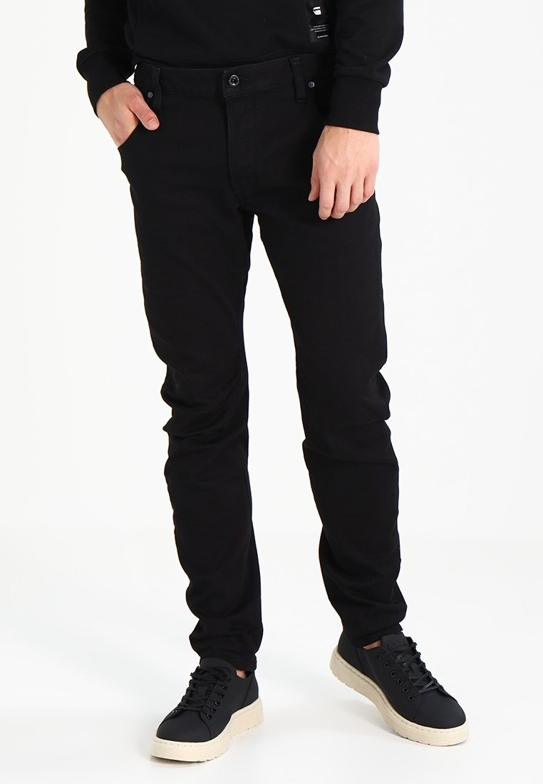 Black denim jeans with a slim fit and a classic five-pocket design, featuring a button closure and a smooth, textured finish.